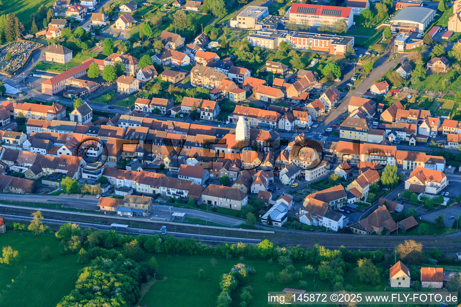 Town center at the train station with scaffolded church tower in Diemeringen in the state Bas-Rhin, France
