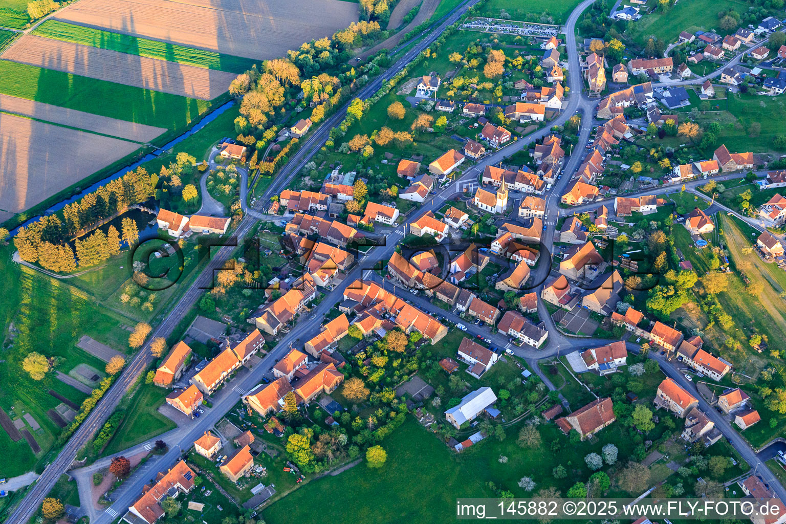 Two churches in the village center from the northwest in Vœllerdingen in the state Bas-Rhin, France