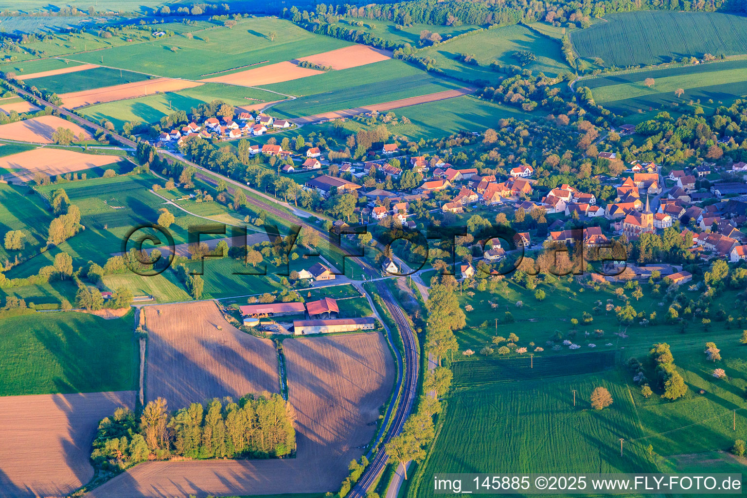 Course of the railway line on the edge of the village from the north in Domfessel in the state Bas-Rhin, France