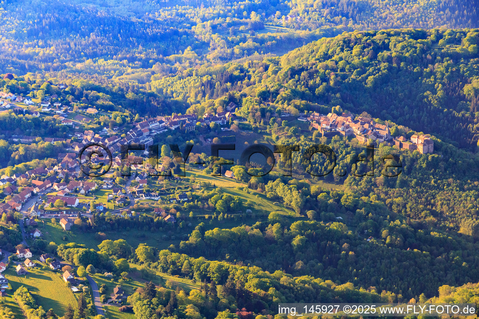 View of the hilly Alsace region of the Northern Vosges with Lützelstein Castle / Château de La Petite-Pierre in the morning from the north in La Petite-Pierre in the state Bas-Rhin, France