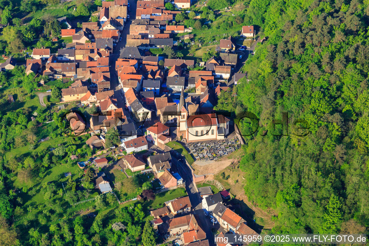 Town hall, church and cemetery in Eckartswiller in the state Bas-Rhin, France