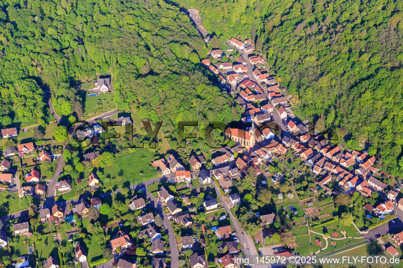 Aerial view of Église Sainte Marie Auxiliatrice and Rue du Cimetière in Ottersthal in the state Bas-Rhin, France