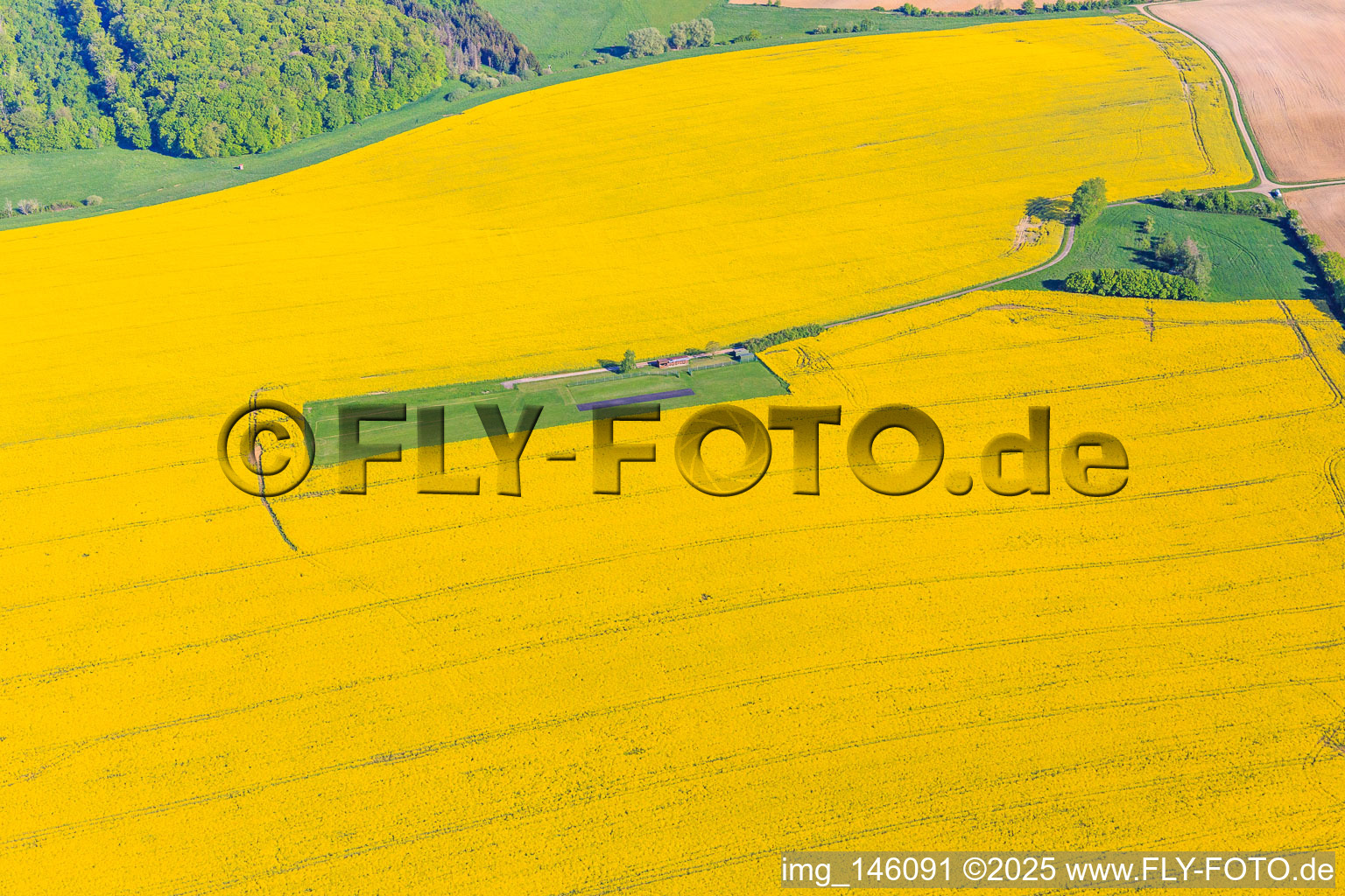 Model airfield in a blooming rapeseed field in Gros-Réderching in the state Moselle, France