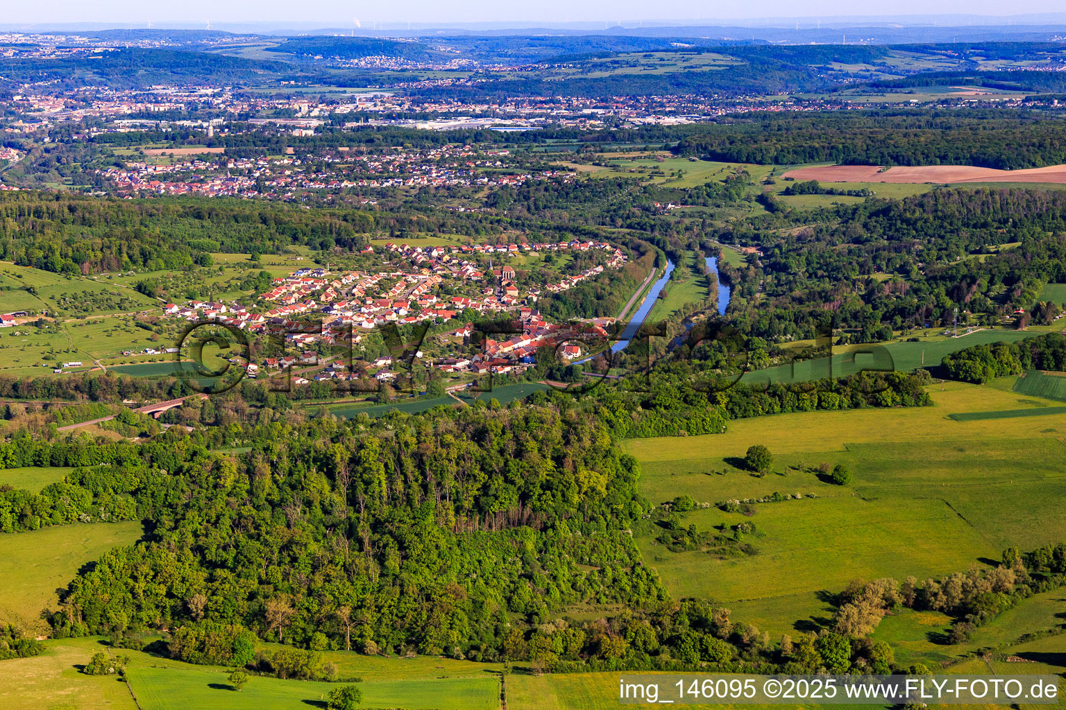 Aerial view of View of the town on the Saar and the Canal des houllères de la Sarre from the southeast in Wittring in the state Moselle, France