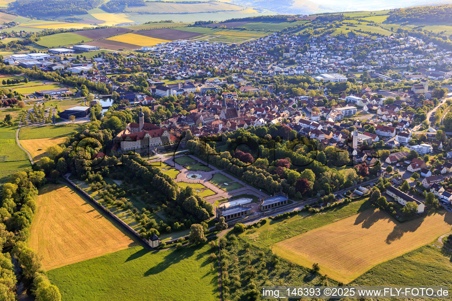 Oblique view of Castle and castle garden Weikersheim (Castle of Count Wolfgang von Hohenlohe from the 17th century with a magnificent knights' hall and garden with statues.) in Weikersheim in the state Baden-Wuerttemberg, Germany