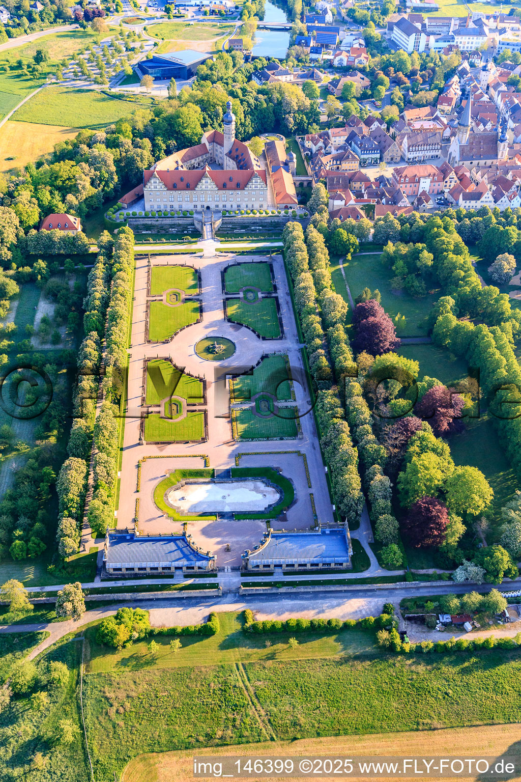 Castle and castle garden Weikersheim (Castle of Count Wolfgang von Hohenlohe from the 17th century with a magnificent knights' hall and garden with statues.) in Weikersheim in the state Baden-Wuerttemberg, Germany seen from above