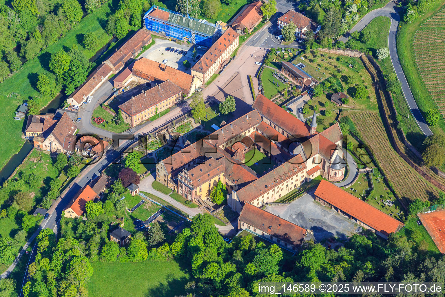 Oblique view of Hotel Kloster Bronnbach with Abbey Garden, Abbey Church of the Assumption of Mary and Missionaries of the Holy Family Monastery Bronnbach from the south in the district Bronnbach in Wertheim in the state Baden-Wuerttemberg, Germany