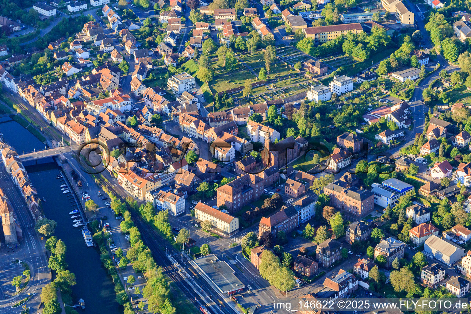 Train station and Tauber Bridge and Church of St. Venantius in Wertheim in the state Baden-Wuerttemberg, Germany