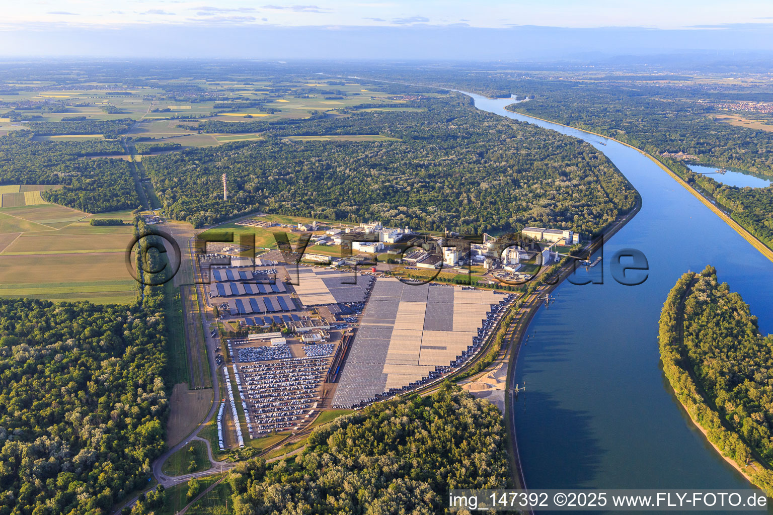 Aerial photograpy of Industrial and Port Zone with industrial facilities on the Rhine belonging to Jungbunzlauer SA and TEREOS Starch & Sweeteners Europe in front of the CEVA Logistics car warehouse in Marckolsheim in the state Bas-Rhin, France