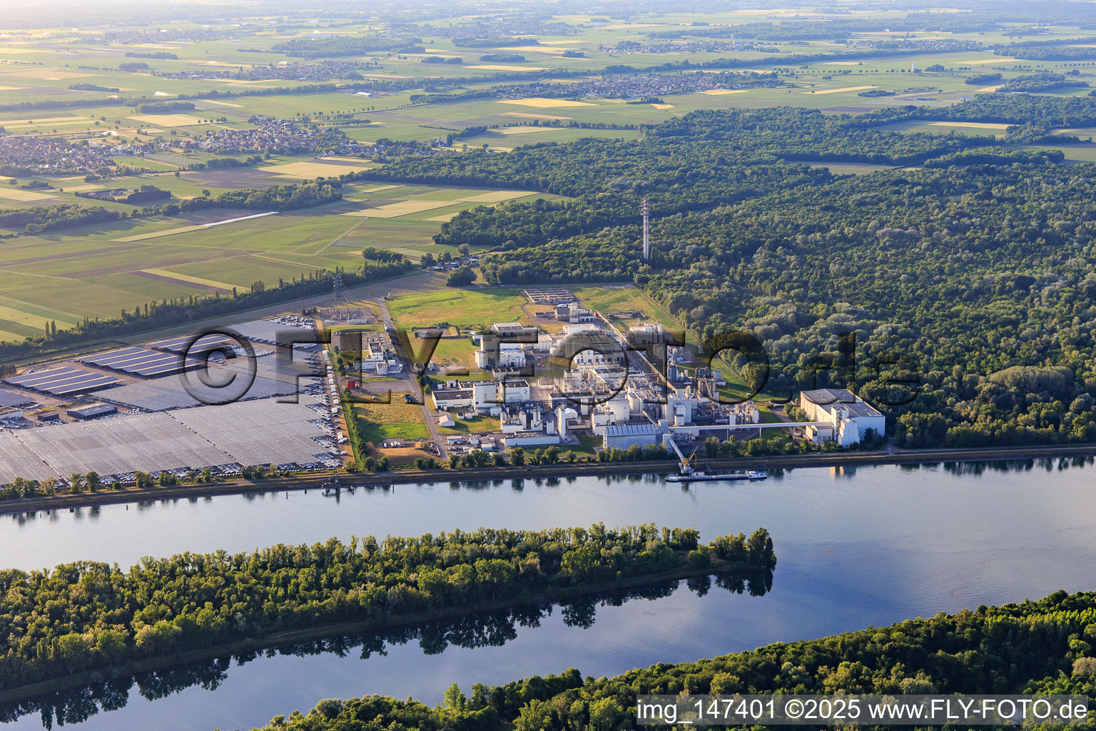 Industrial and Port Zone with industrial facilities on the Rhine from the southeast of Jungbunzlauer SA and TEREOS Starch & Sweeteners Europe in front of the CEVA Logistics car warehouse in Marckolsheim in the state Bas-Rhin, France