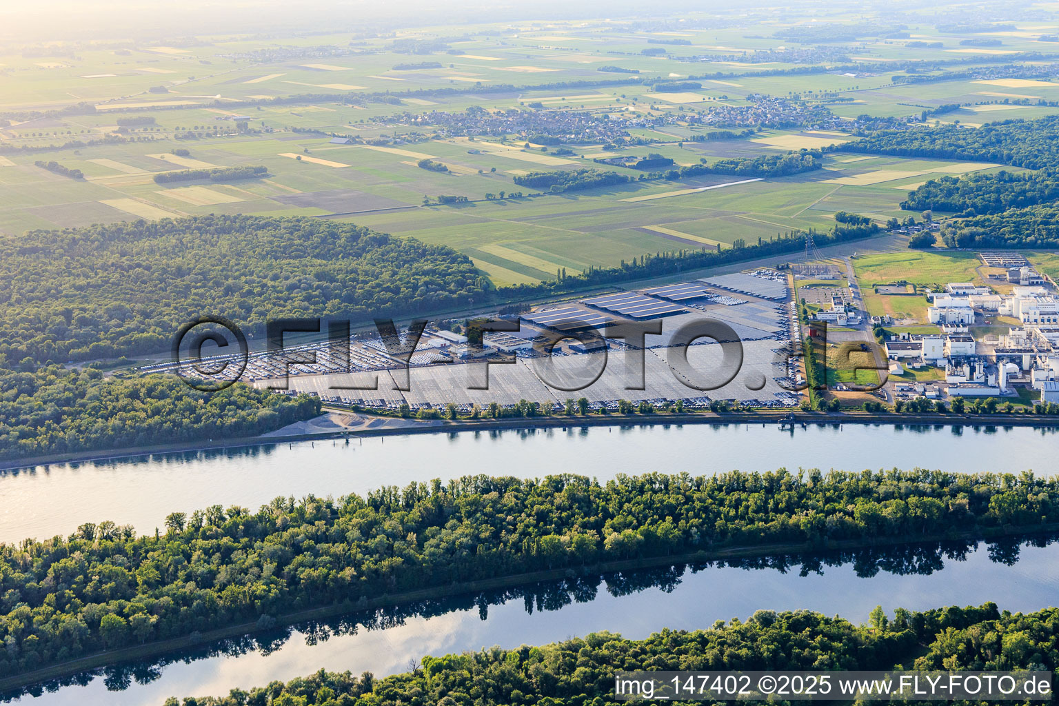 Aerial view of Industrial and Port Zone with industrial facilities on the Rhine from the southeast of Jungbunzlauer SA and TEREOS Starch & Sweeteners Europe in front of the CEVA Logistics car warehouse in Marckolsheim in the state Bas-Rhin, France