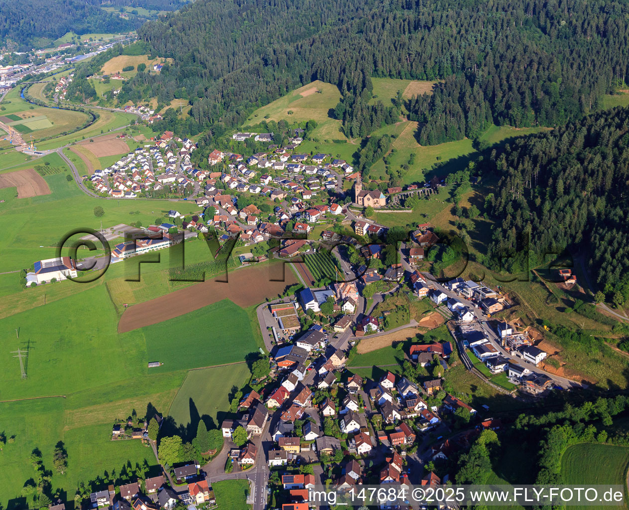 View of the town from the east with St. Michael's Church and Wolf's fruit farm in Fischerbach in the state Baden-Wuerttemberg, Germany