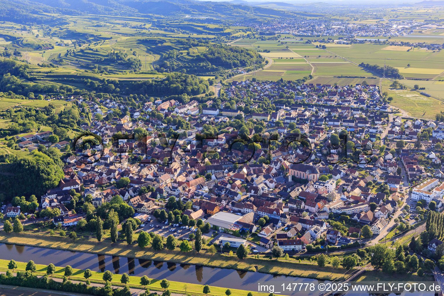 City view beyond the Leopold Canal from the east in Riegel am Kaiserstuhl in the state Baden-Wuerttemberg, Germany