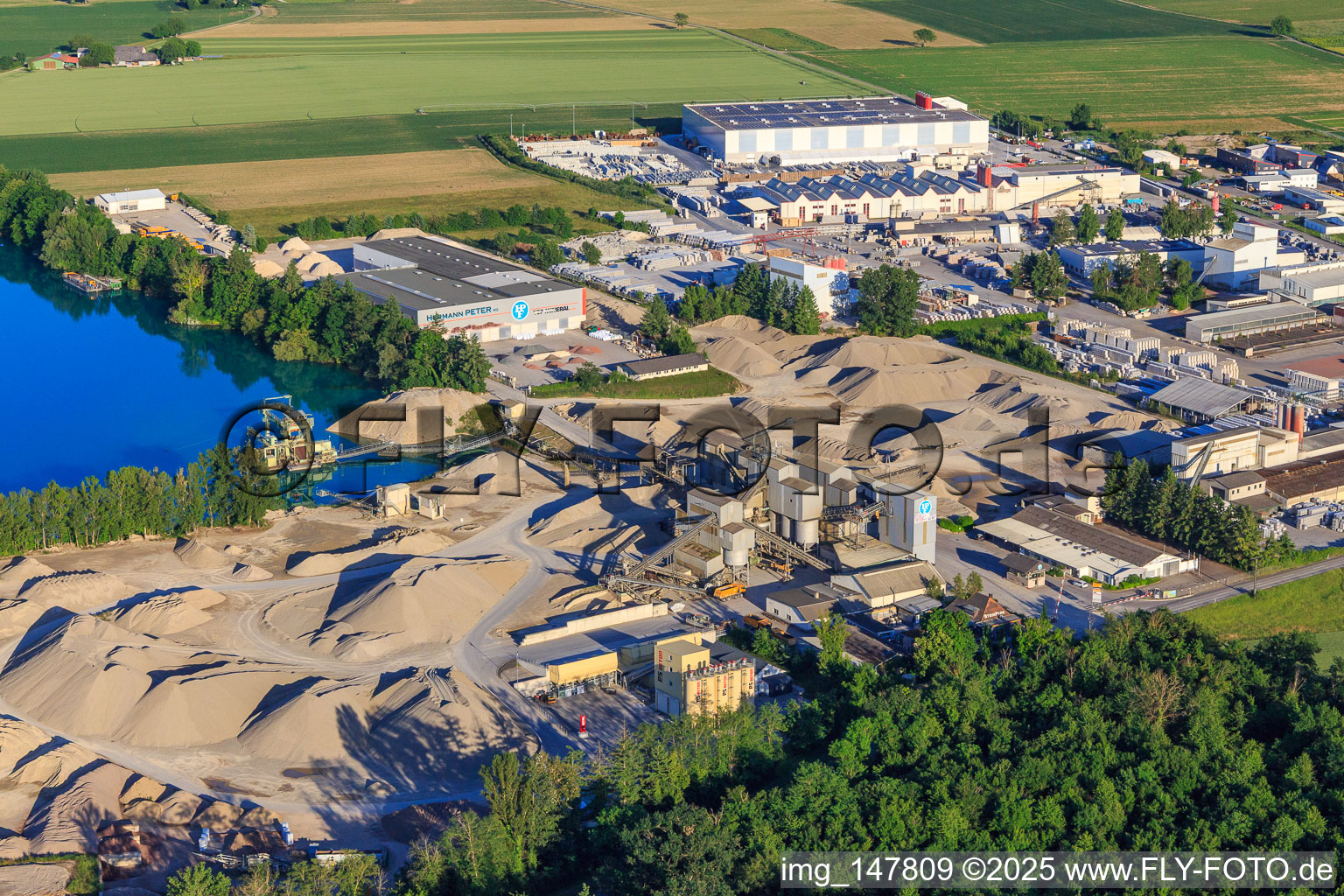 Rimsinger Baggersee / Niederrimsingen gravel pit with P & S-Beton GmbH & Co. KG, Birkenmeier Stein + Design GmbH and H+H Kalksandstein GmbH in the district Oberrimsingen in Breisach am Rhein in the state Baden-Wuerttemberg, Germany