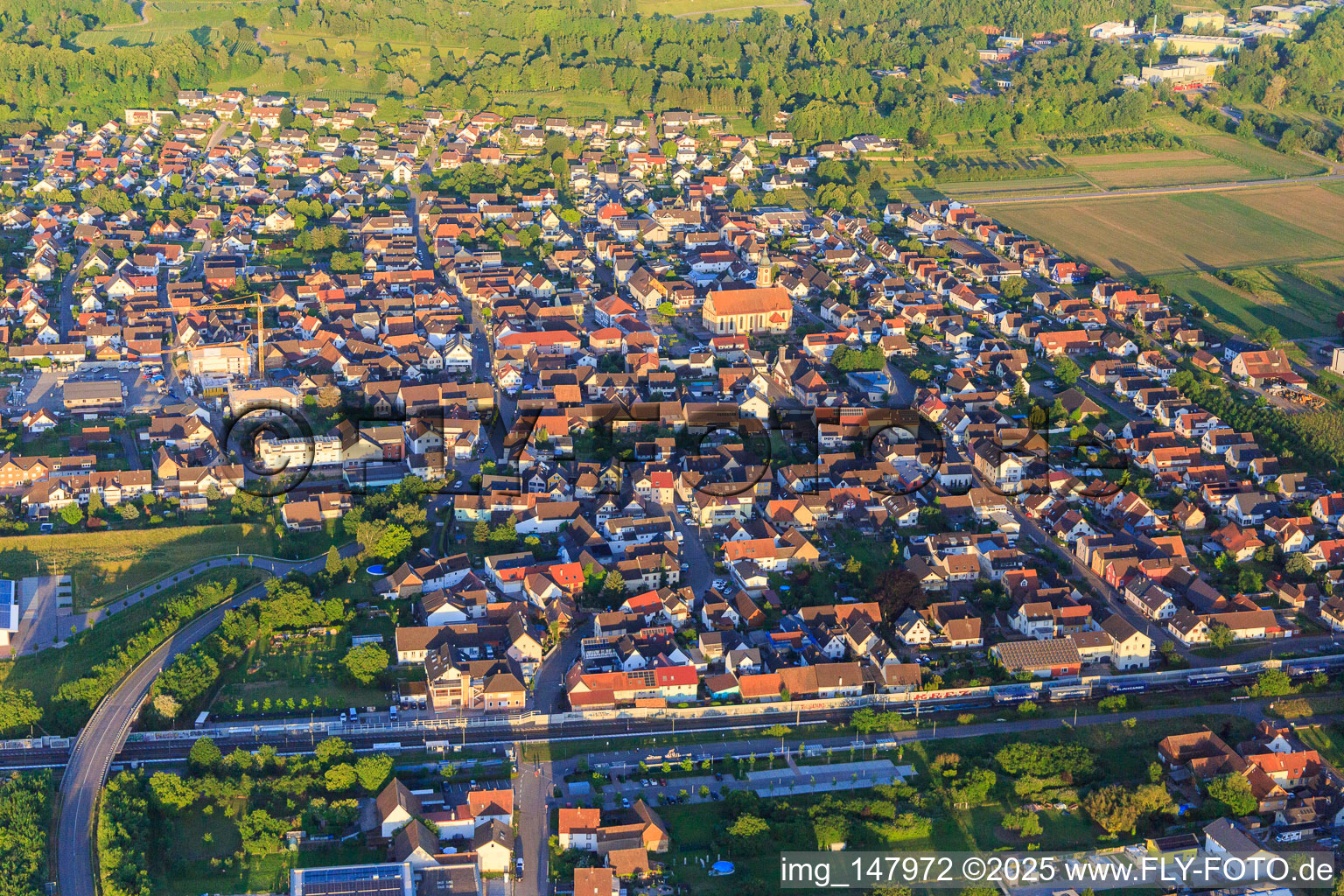 View of the town beyond the railway line from the west in Ringsheim in the state Baden-Wuerttemberg, Germany
