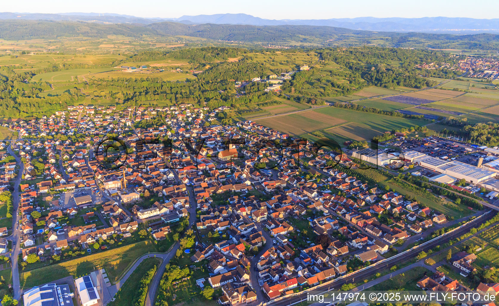 View of the town beyond the railway line from the northwest in Ringsheim in the state Baden-Wuerttemberg, Germany
