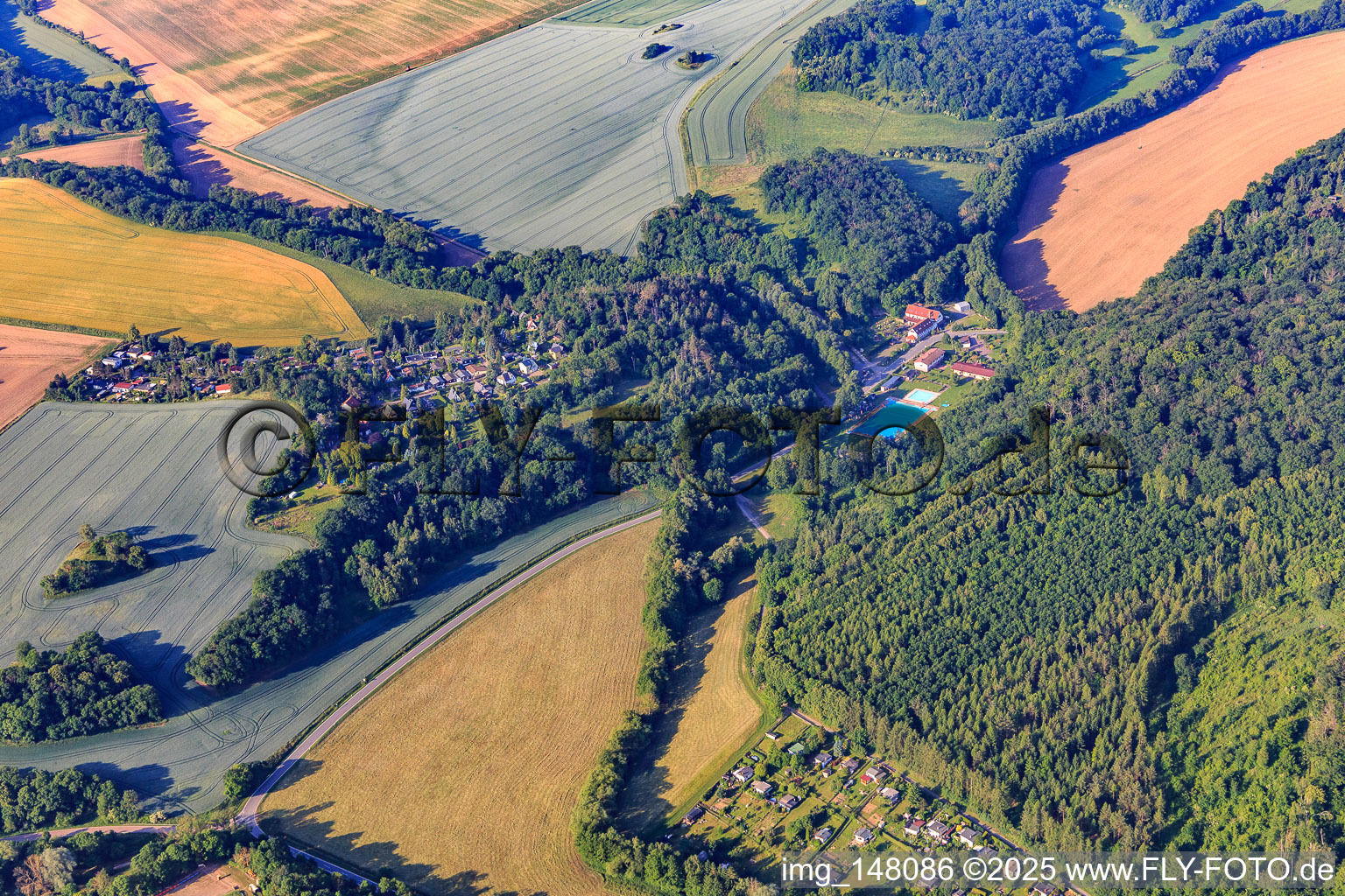 Village view with forest pool from the north in the district Alterode in Arnstein in the state Saxony-Anhalt, Germany