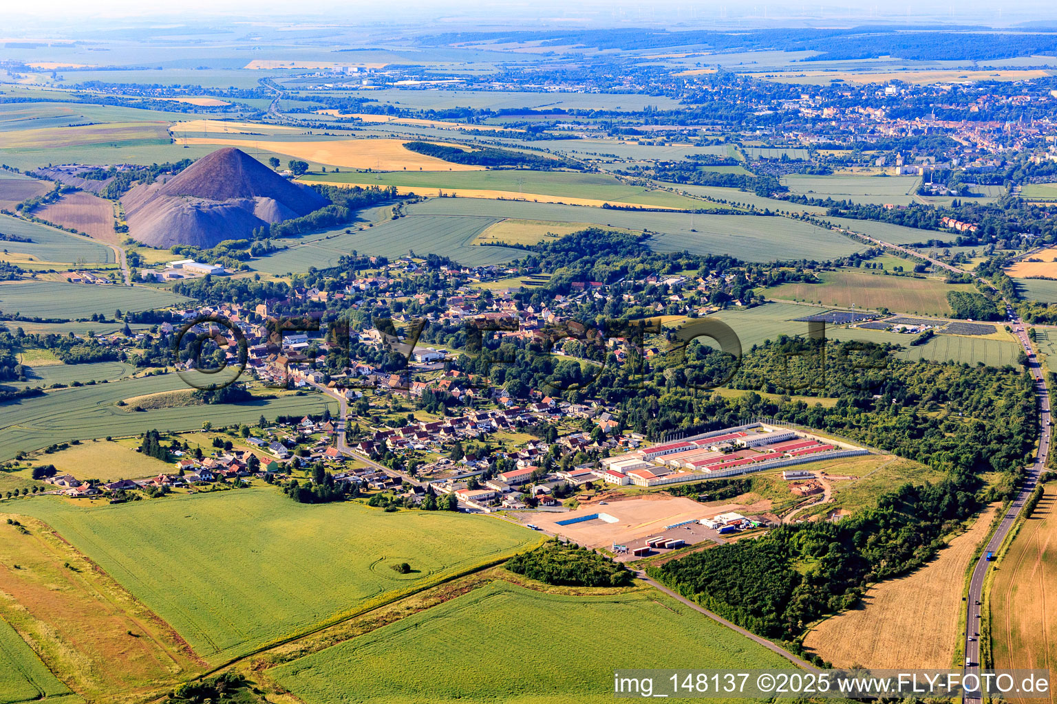 Village view in front of the "Fortschrittschacht" spoil heap from the north in the district Volkstedt in Eisleben in the state Saxony-Anhalt, Germany
