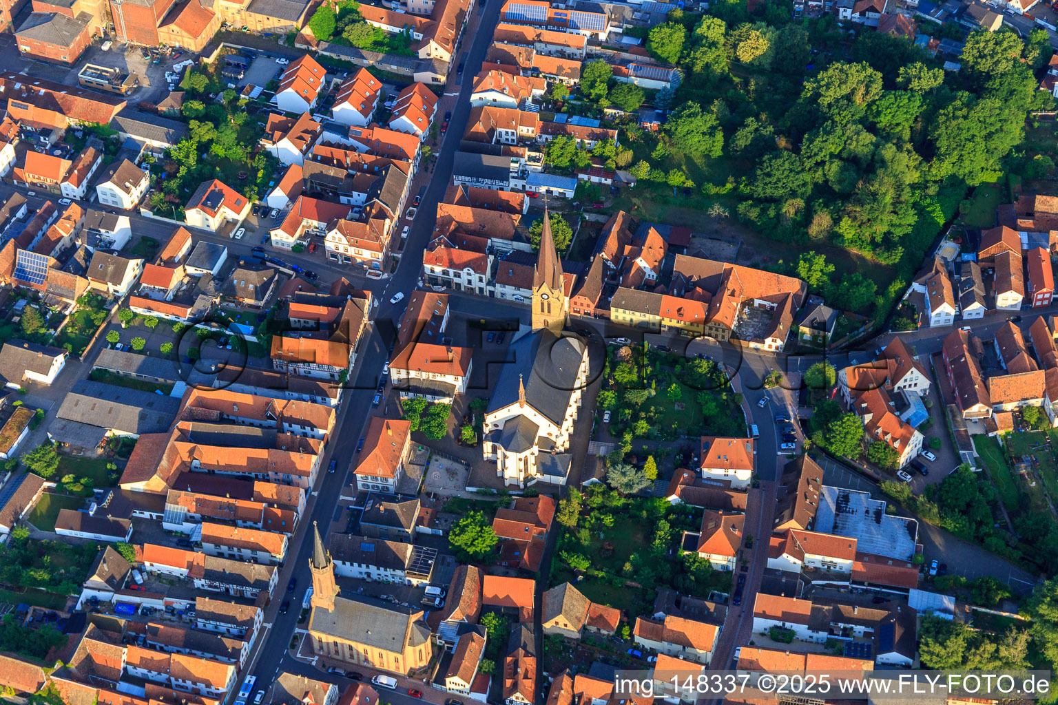 Aerial photograpy of Catholic Church of St. Nicholas and Protestant Church Bellheim on Hauptstr in Bellheim in the state Rhineland-Palatinate, Germany