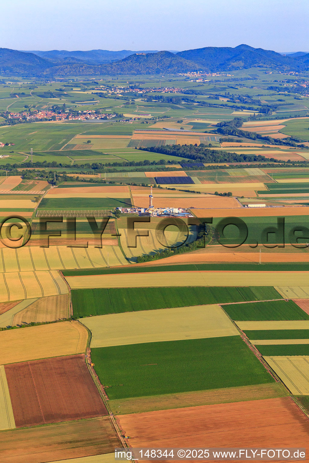 Drilling site of the deep drilling rig V20 of Vercana GmbH for Vulcan Energy at Schleidberg for the extraction of geothermal energy and lithium in Insheim in the state Rhineland-Palatinate, Germany from the drone perspective