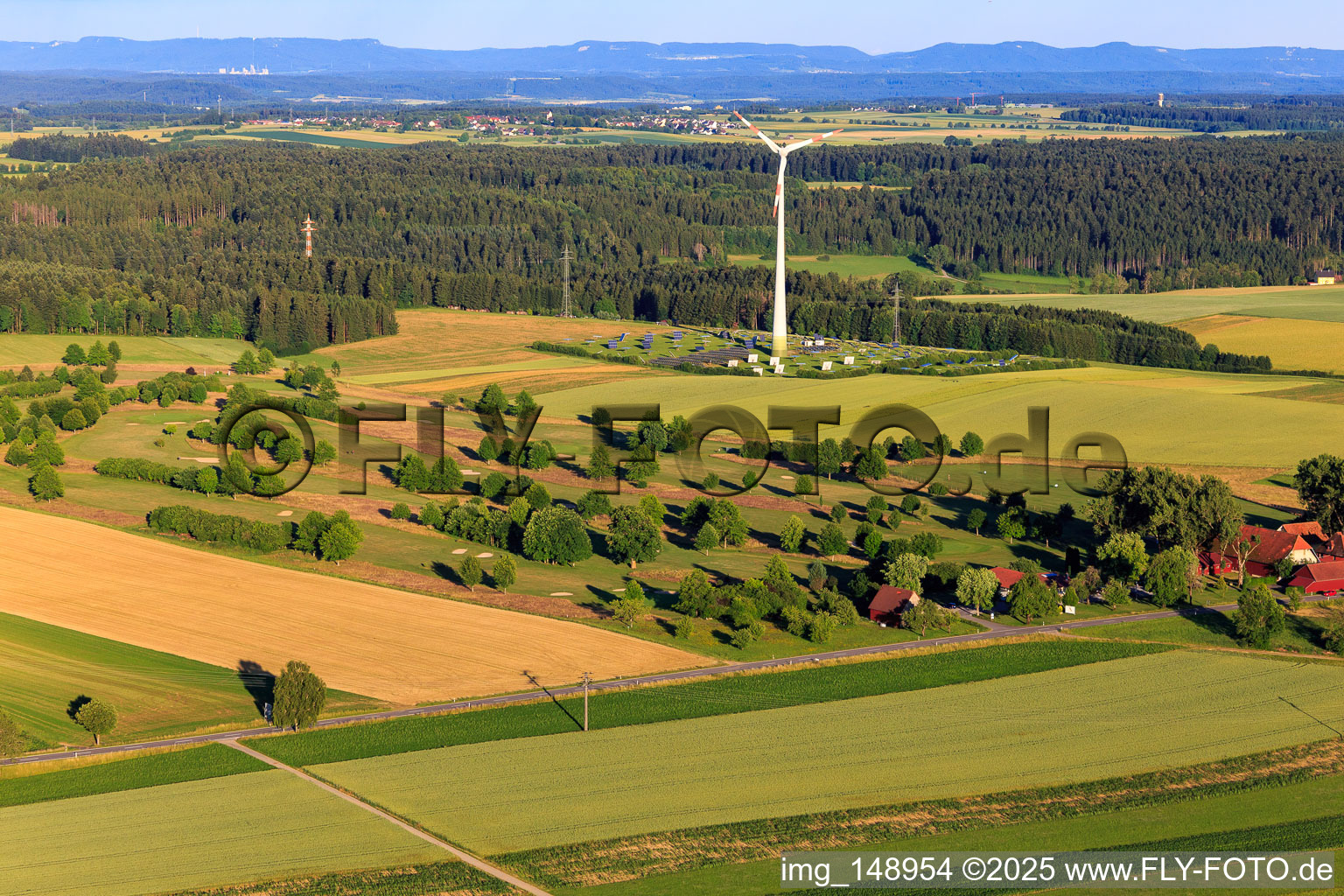 Wind energy plant above open-space PV system behind the golf club Alpirsbach eV in the district Peterzell in Alpirsbach in the state Baden-Wuerttemberg, Germany