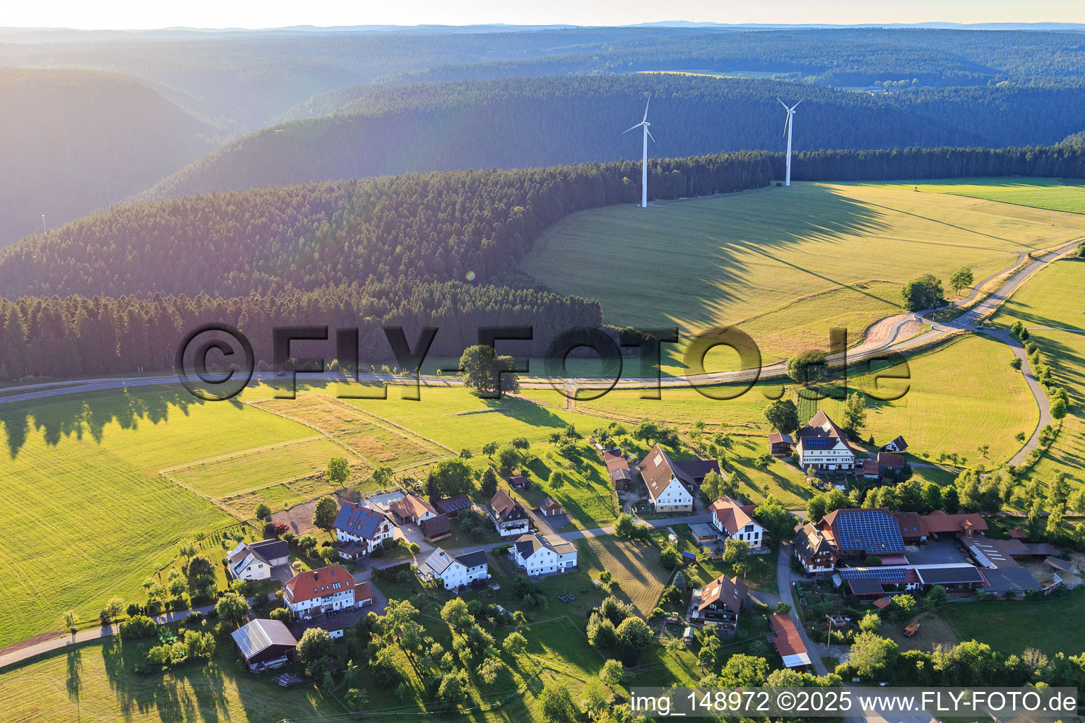 Village view from the east with two wind turbines in the district Äußerer Vogelsberg in Loßburg in the state Baden-Wuerttemberg, Germany