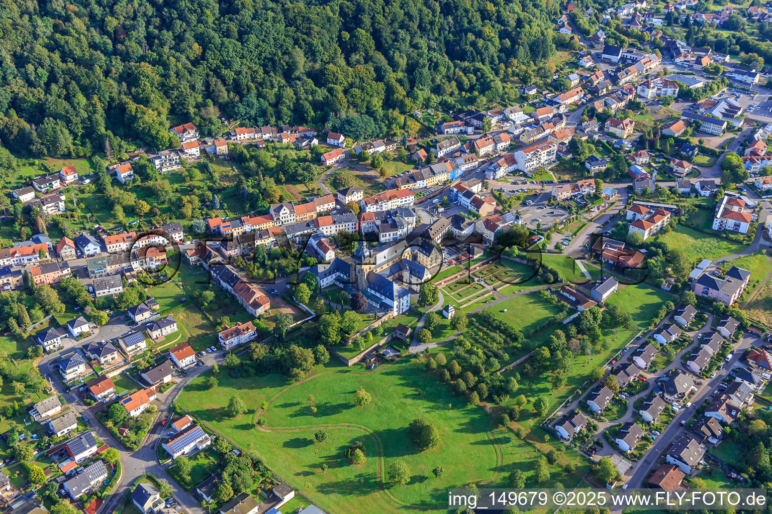 Town center with Benedictine Abbey of St. Mauritius Tholey with abbey church and monastery garden from the southwest in Tholey in the state Saarland, Germany