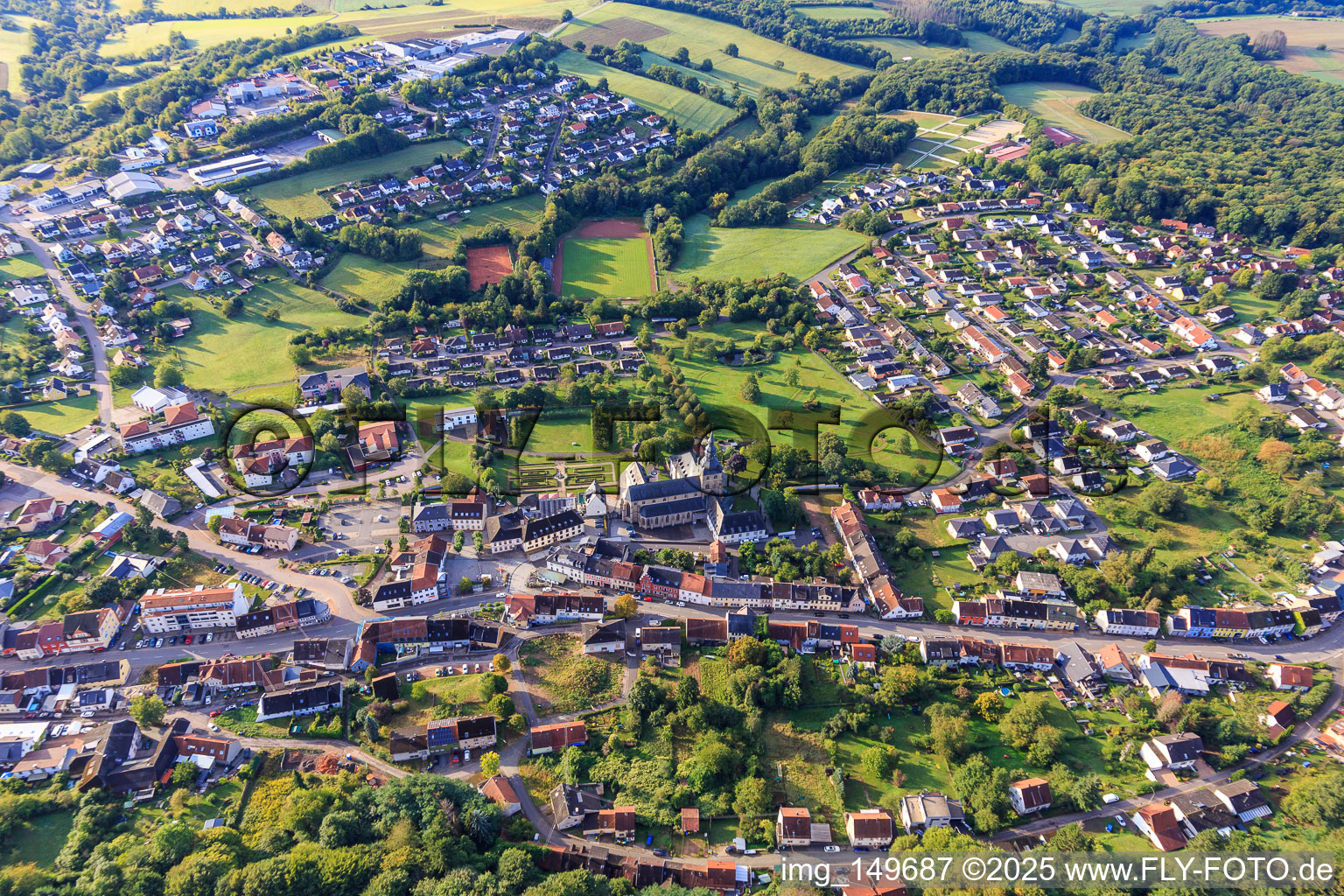 Town center with Benedictine Abbey of St. Mauritius Tholey with abbey church and monastery garden from the north in Tholey in the state Saarland, Germany
