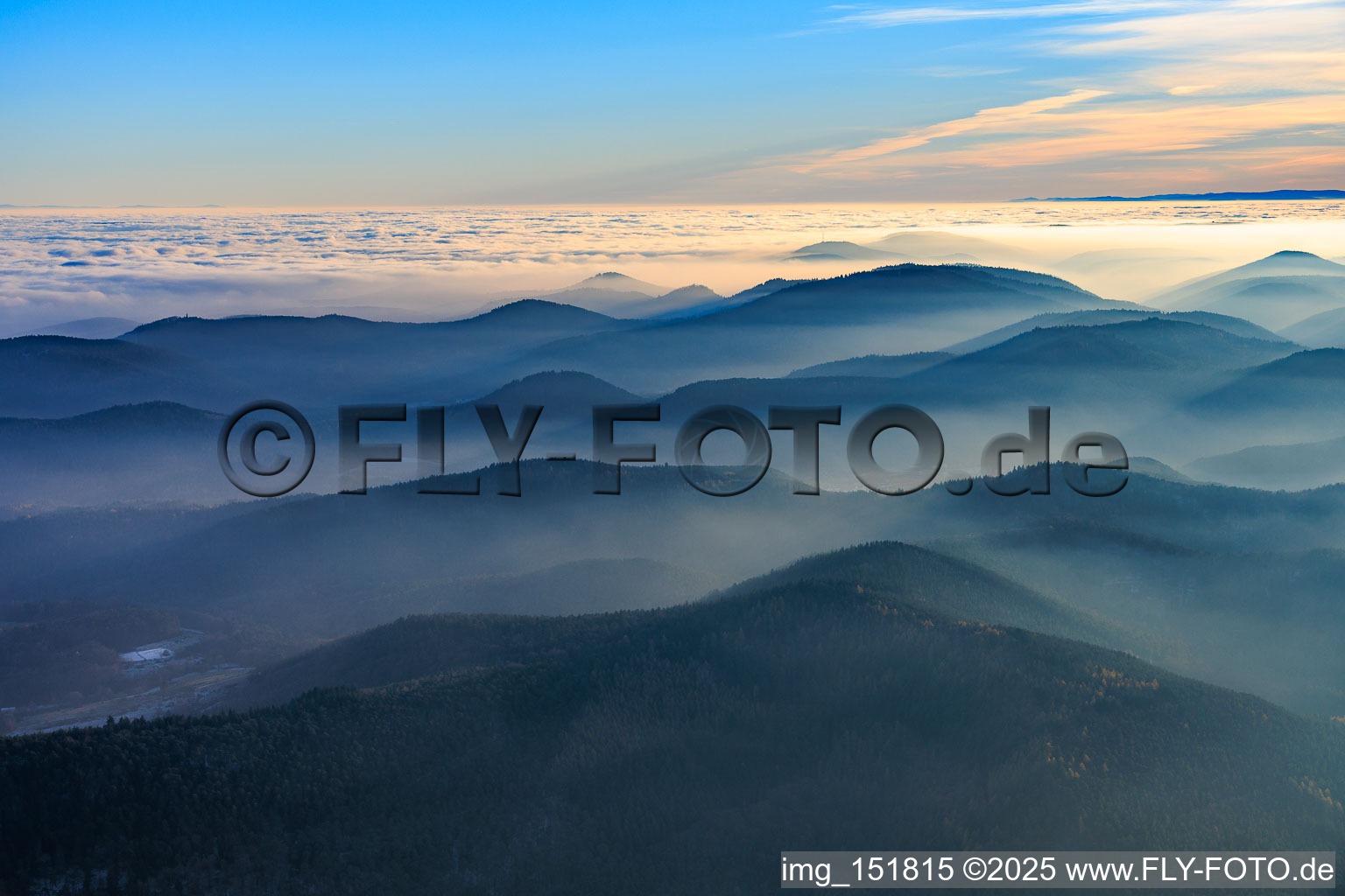 Hills of the Palatinate Forest and the Northern Vosges Mountains in the evening mist in Silz in the state Rhineland-Palatinate, Germany