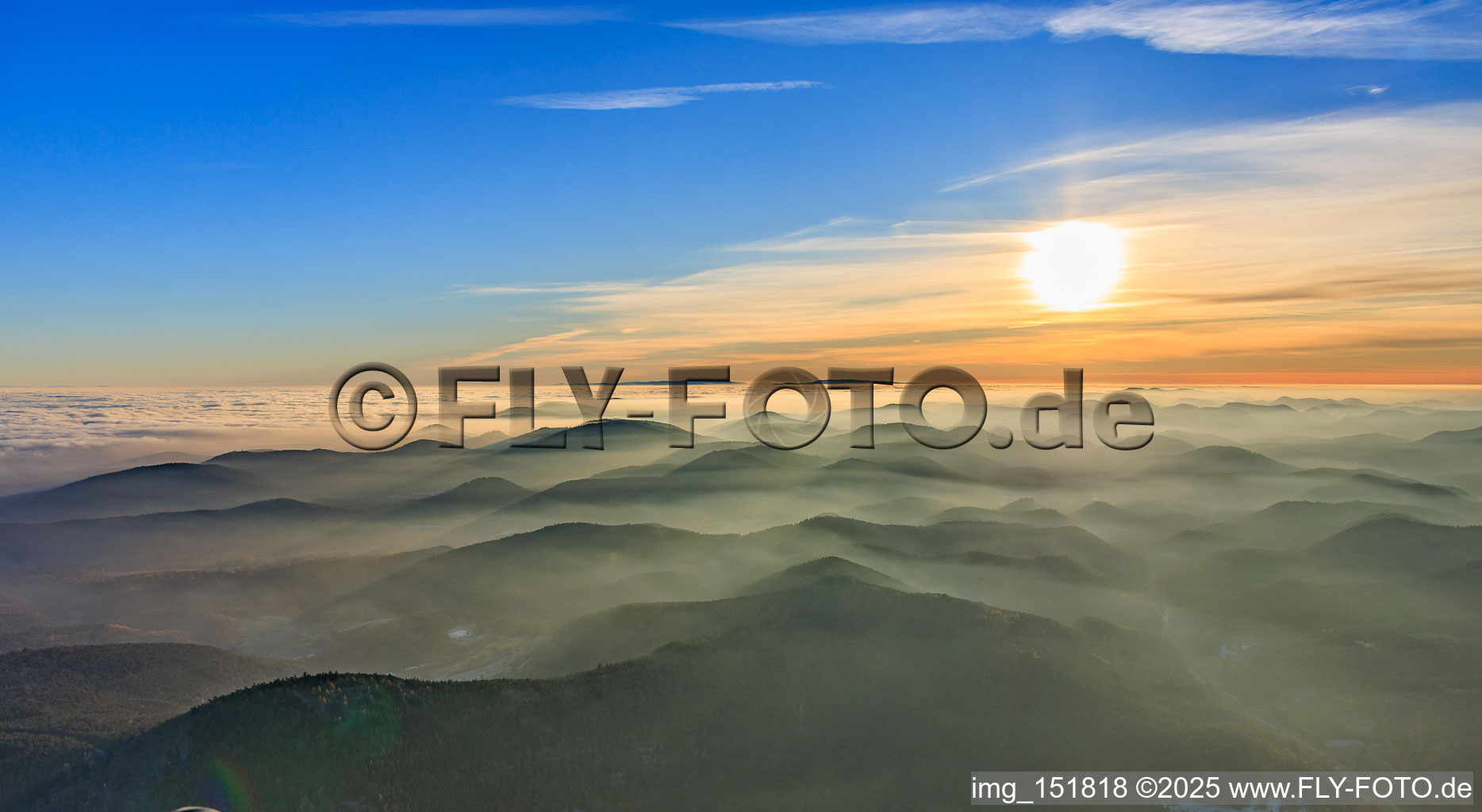 Panorama of the Palatinate Forest and Northern Vosges Mountains in the evening haze in Birkenhördt in the state Rhineland-Palatinate, Germany