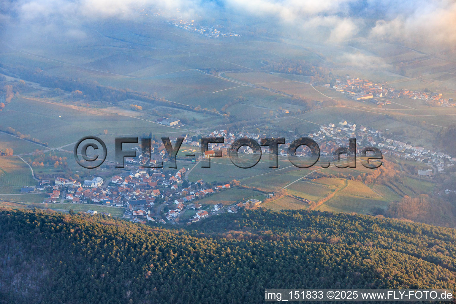 View of the town from the west with the Dionysius Chapel between clouds and mountains in the district Gleiszellen in Gleiszellen-Gleishorbach in the state Rhineland-Palatinate, Germany