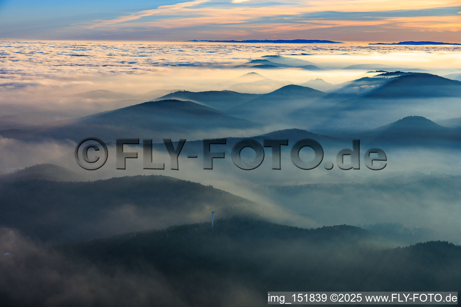 Panorama of the Palatinate Forest and the Northern Vosges Mountains in the evening haze - in the foreground the Stäffelsberg Tower in Klingenmünster in the state Rhineland-Palatinate, Germany