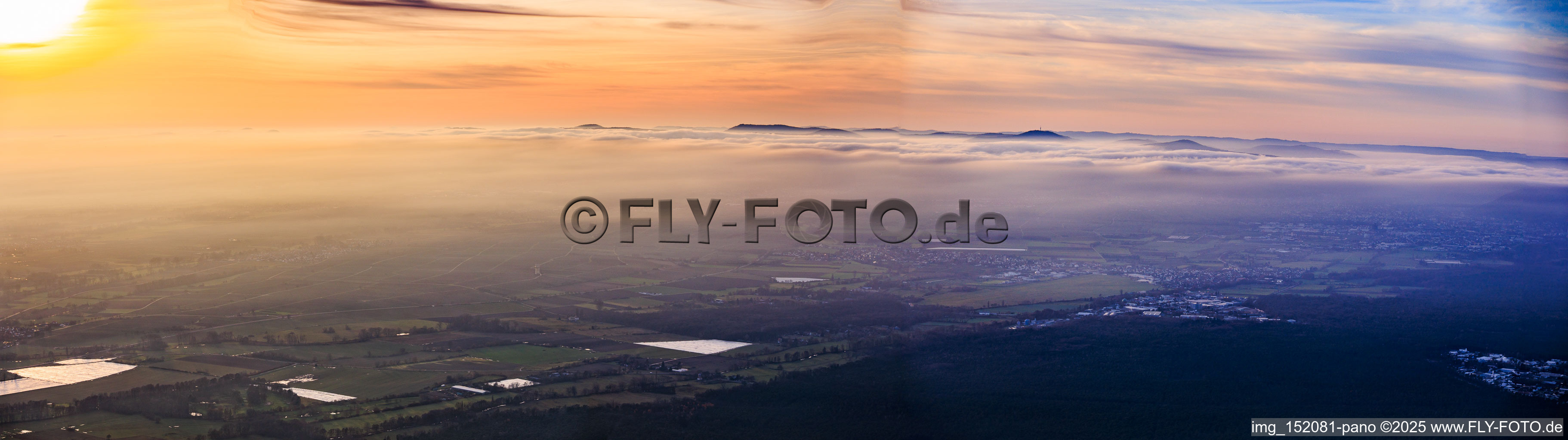 Sunset over winter fog at the Haardt Mountains in the district Speyerdorf in Neustadt an der Weinstraße in the state Rhineland-Palatinate, Germany