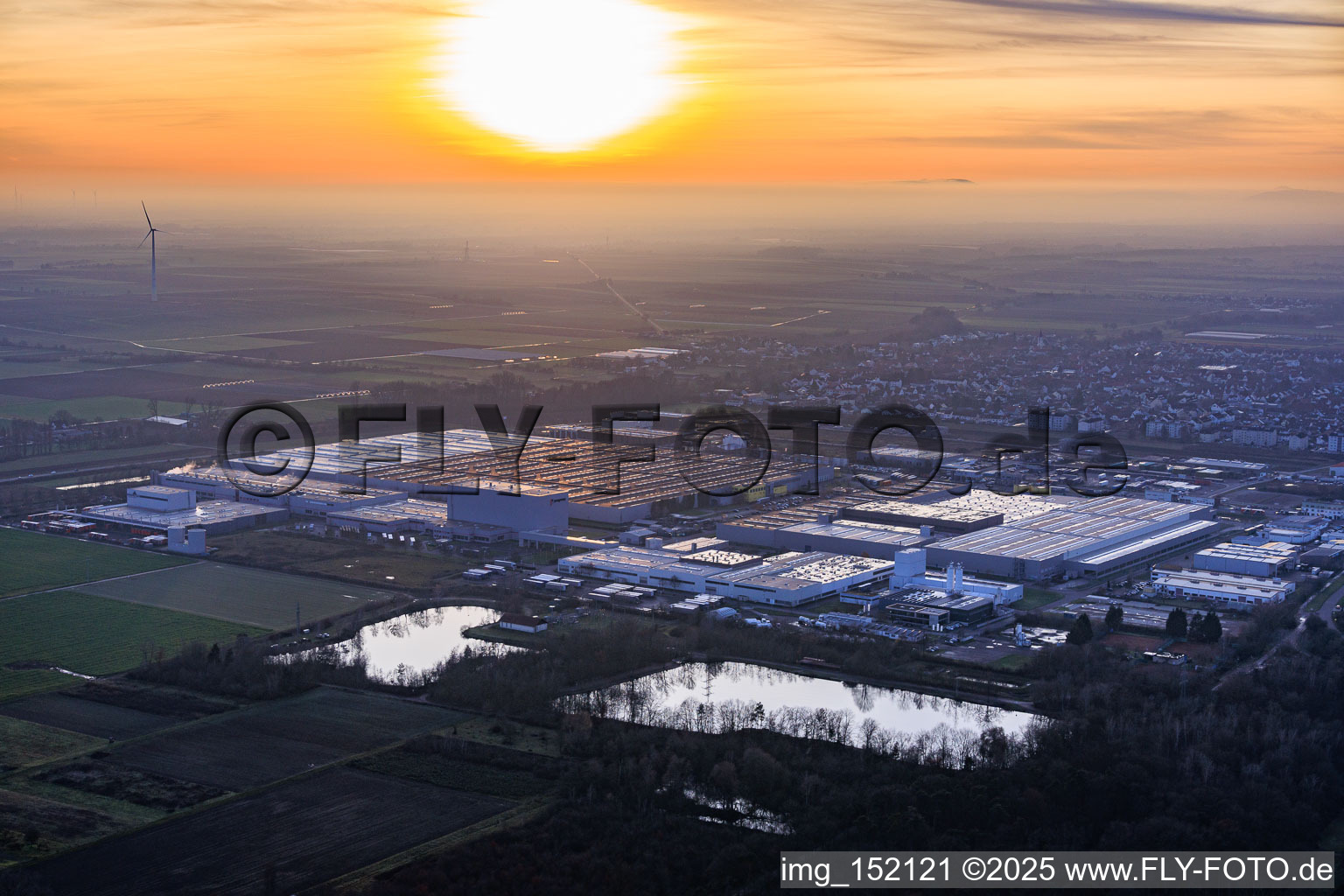 Aerial view of Interpark industrial park seen from the northeast on a foggy winter evening in Offenbach an der Queich in the state Rhineland-Palatinate, Germany