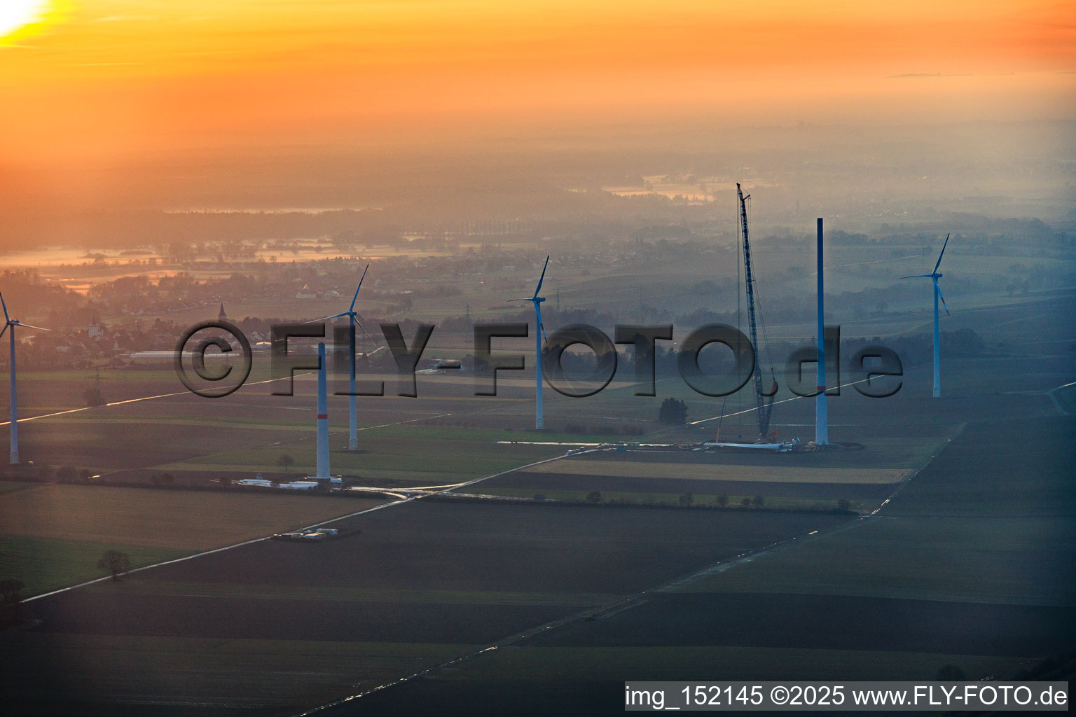 Sunset during the repowering of wind farm Minfeld. JUWI is replacing four old turbines (GE 1.5) from 2004 with two new, modern Vestas V162 turbines, each with a capacity of six MW. in Minfeld in the state Rhineland-Palatinate, Germany