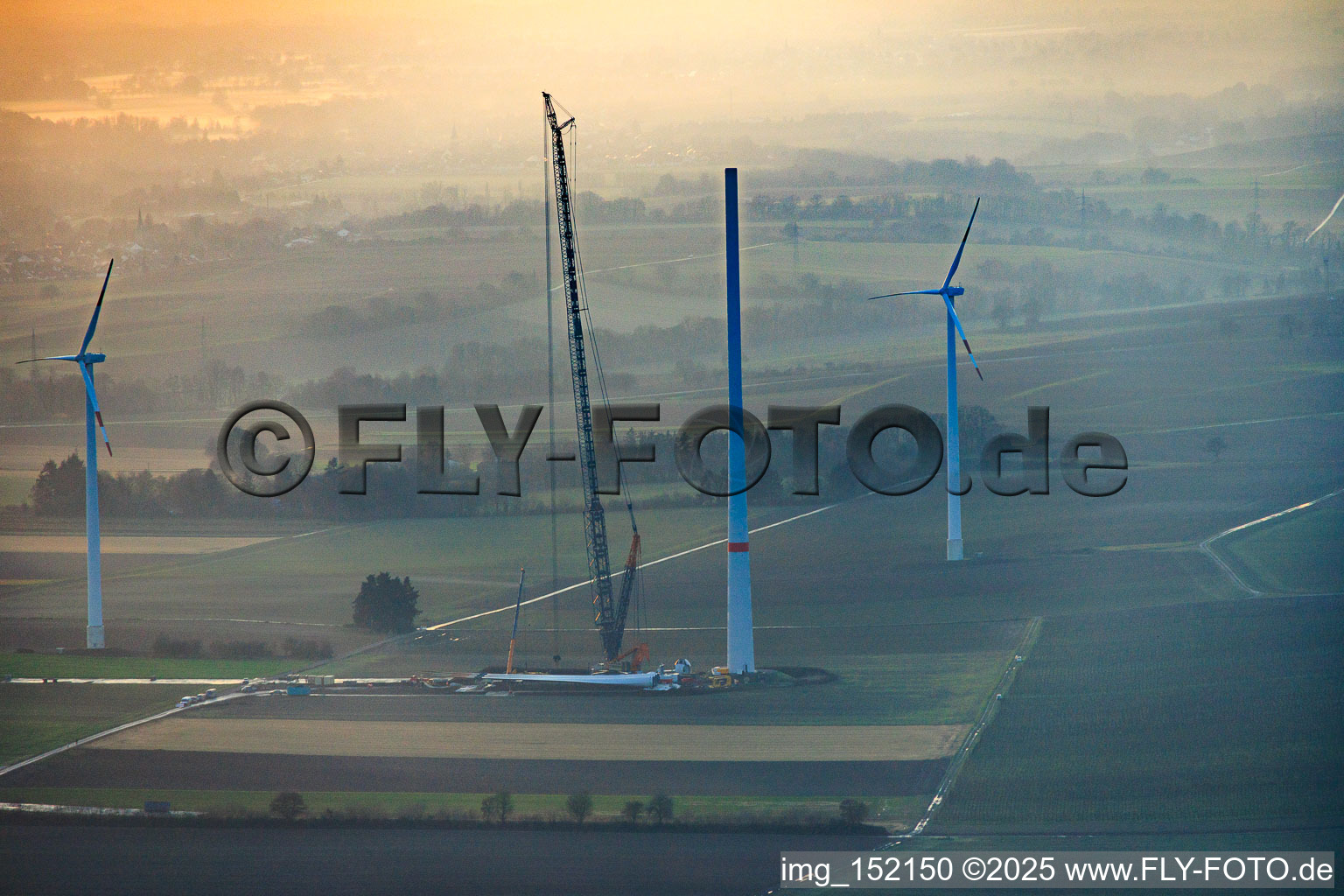 Aerial view of Sunset during the repowering of wind farm Minfeld. JUWI is replacing four old turbines (GE 1.5) from 2004 with two new, modern Vestas V162 turbines, each with a capacity of six MW. in Minfeld in the state Rhineland-Palatinate, Germany