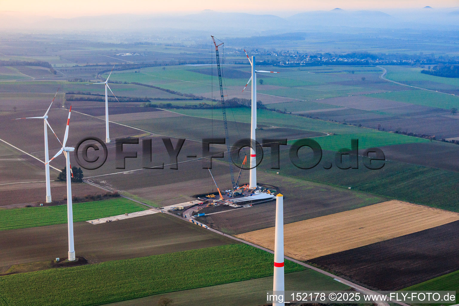 Giant crane for the repowering of the wind farm Minfeld. JUWI is replacing four old turbines (GE 1.5) from 2004 with two new, modern Vestas V162 turbines, each with six MW. in Minfeld in the state Rhineland-Palatinate, Germany from above