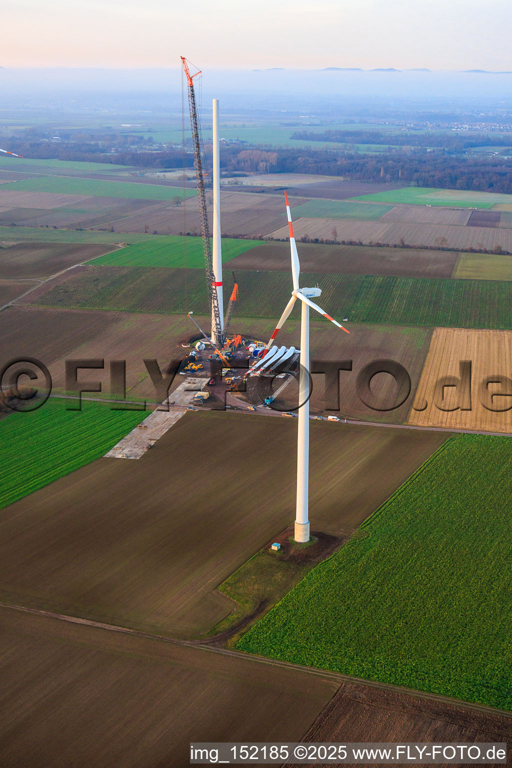 Giant crane for the repowering of the wind farm Minfeld. JUWI is replacing four old turbines (GE 1.5) from 2004 with two new, modern Vestas V162 turbines, each with six MW. in Minfeld in the state Rhineland-Palatinate, Germany seen from above