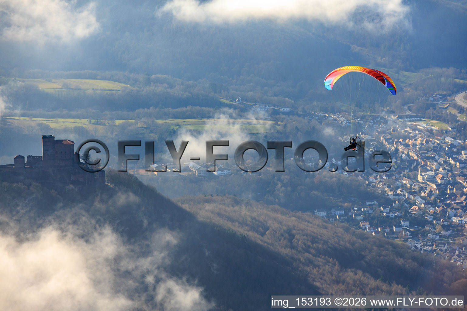 Trifels Castle with paraglider in clouds in Annweiler am Trifels in the state Rhineland-Palatinate, Germany