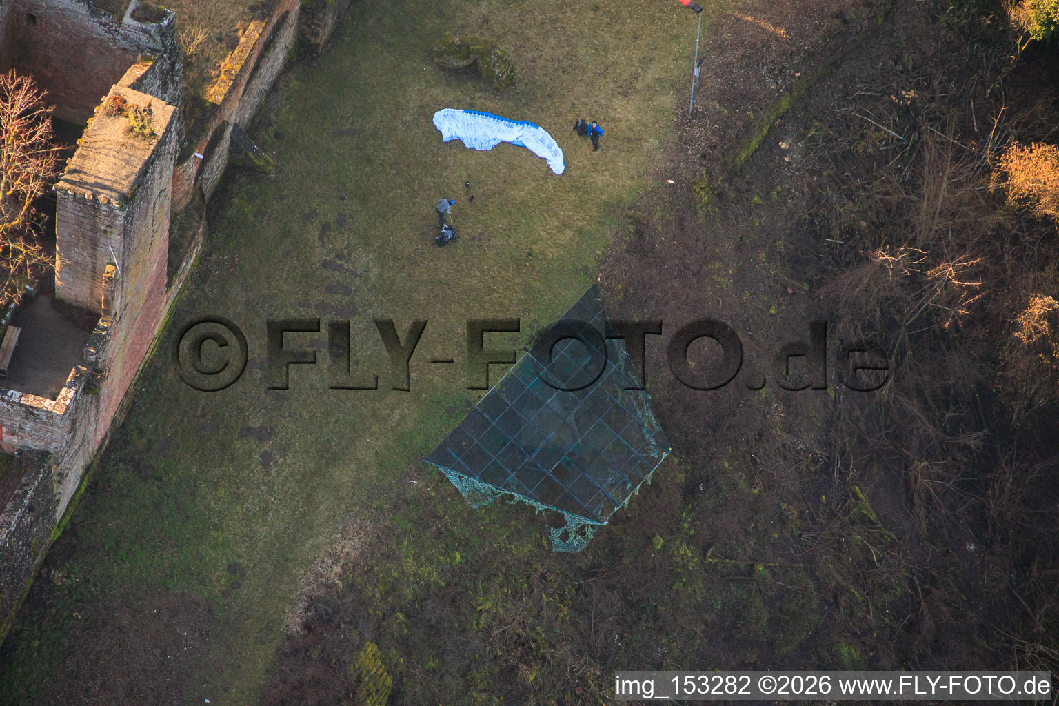 Paraglider pilots preparing for takeoff at the hang-gliding ramp below Madenburg Castle in Eschbach in the state Rhineland-Palatinate, Germany