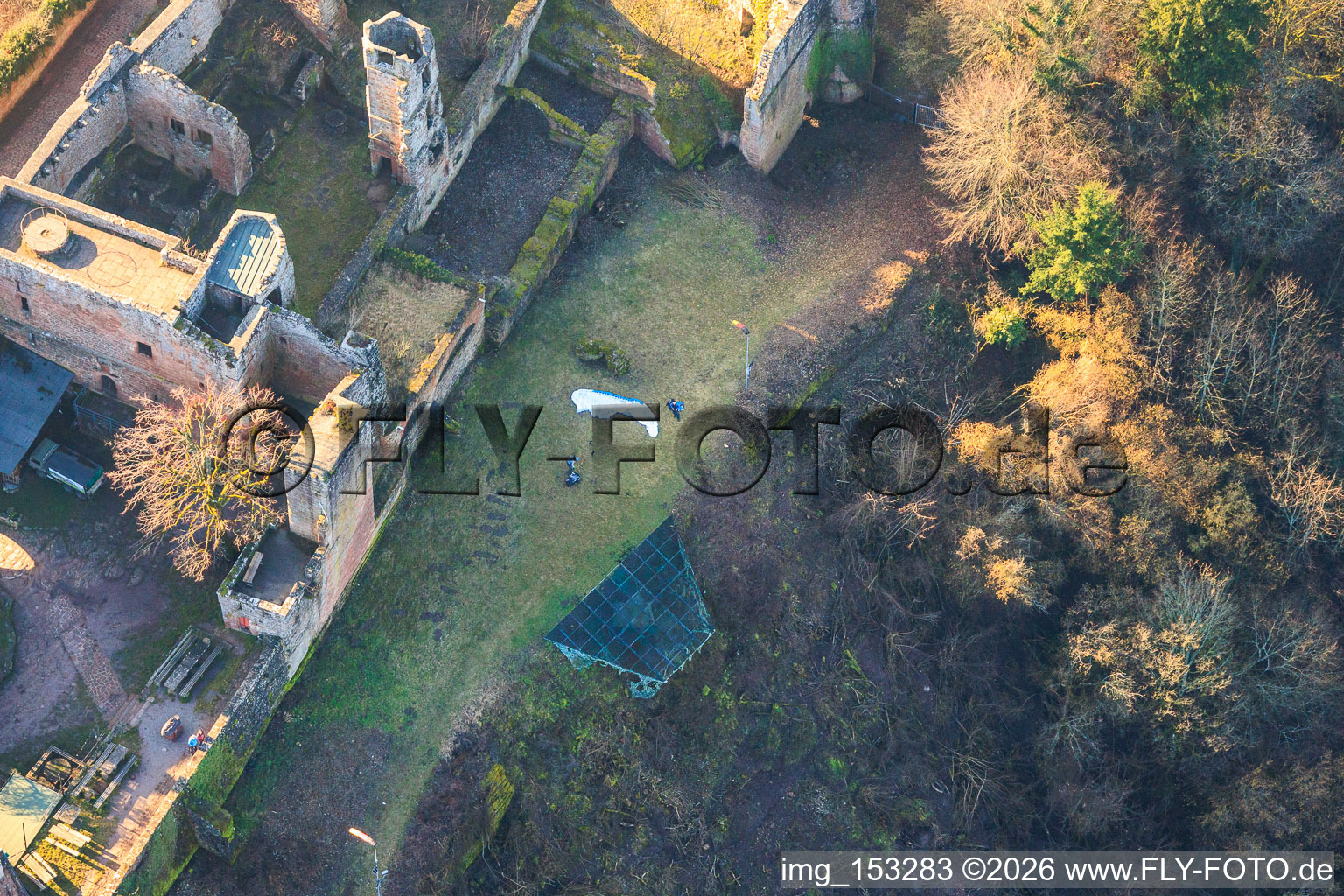 Aerial view of Paraglider pilots preparing for takeoff at the hang-gliding ramp below Madenburg Castle in Eschbach in the state Rhineland-Palatinate, Germany