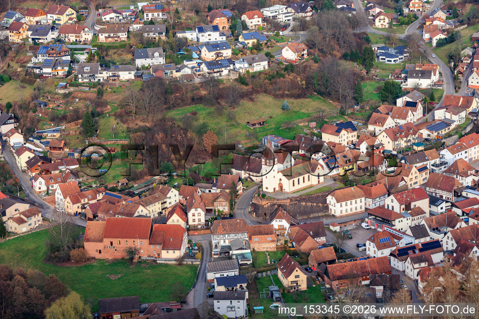 Village view from the west with Wasgau shop and St. Peter and Paul Church in Bundenthal in the state Rhineland-Palatinate, Germany