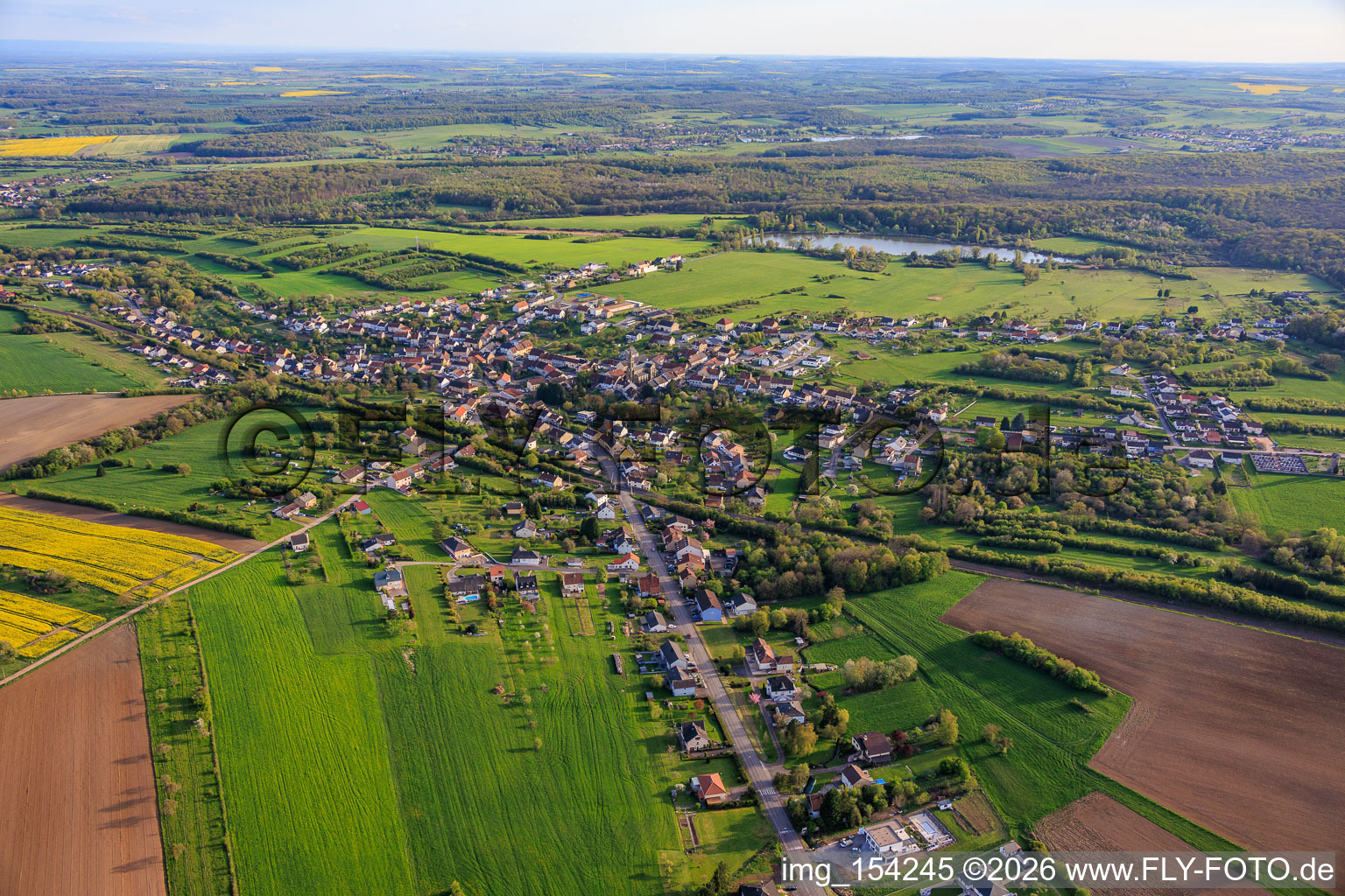 View of the town in front of the pond at Weihergraben from the north in Farschviller in the state Moselle, France