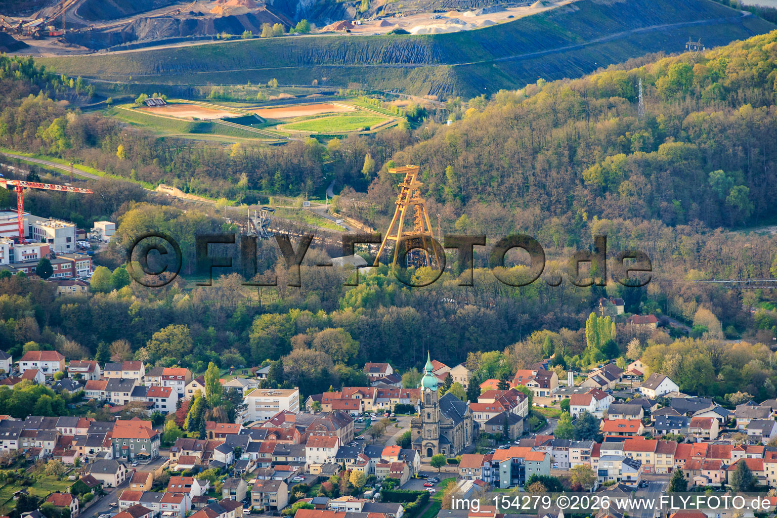 Historic mine headframe Le puits Cuvelette Nord and Saint-Maurice Church in the district Cité de la Chapelle in Freyming-Merlebach in the state Moselle, France