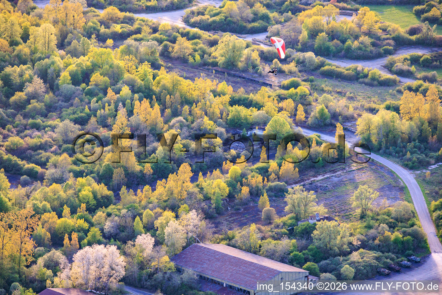 Paragliders over the hangars at the former military airfield Grostenquin in Bistroff in the state Moselle, France