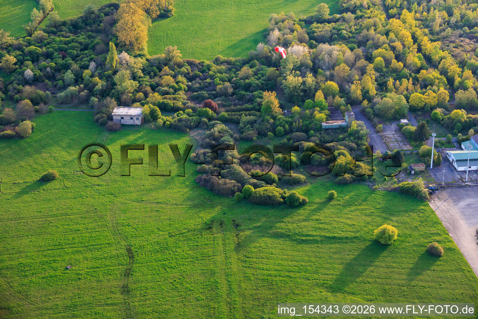 Paragliders over the hangars at the former military airfield Grostenquin in Bistroff in the state Moselle, France