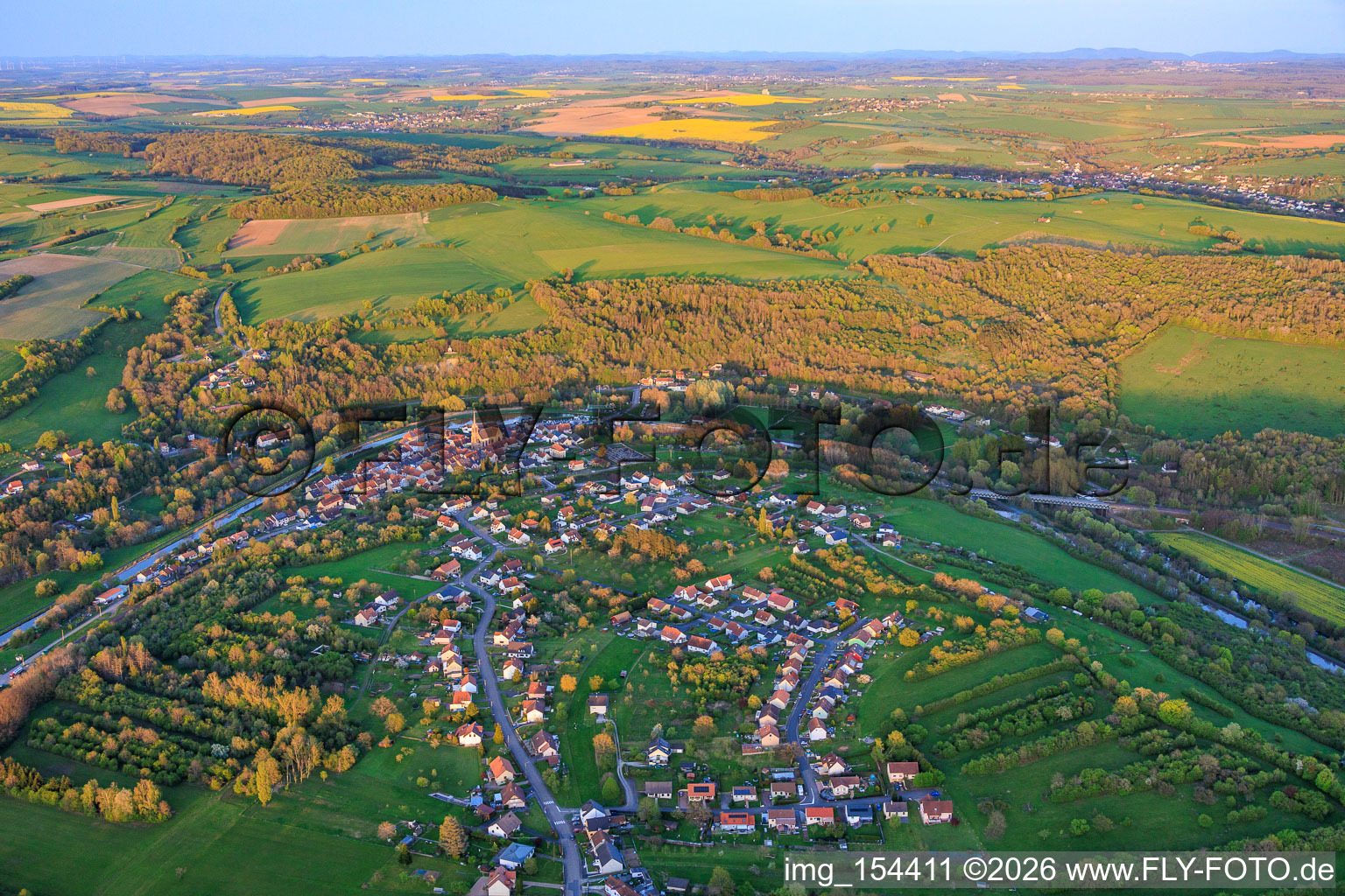 Village view in a bend of the Saar and Canal des Houillères de la Sarre (Saar Canal) in Wittring in the state Moselle, France