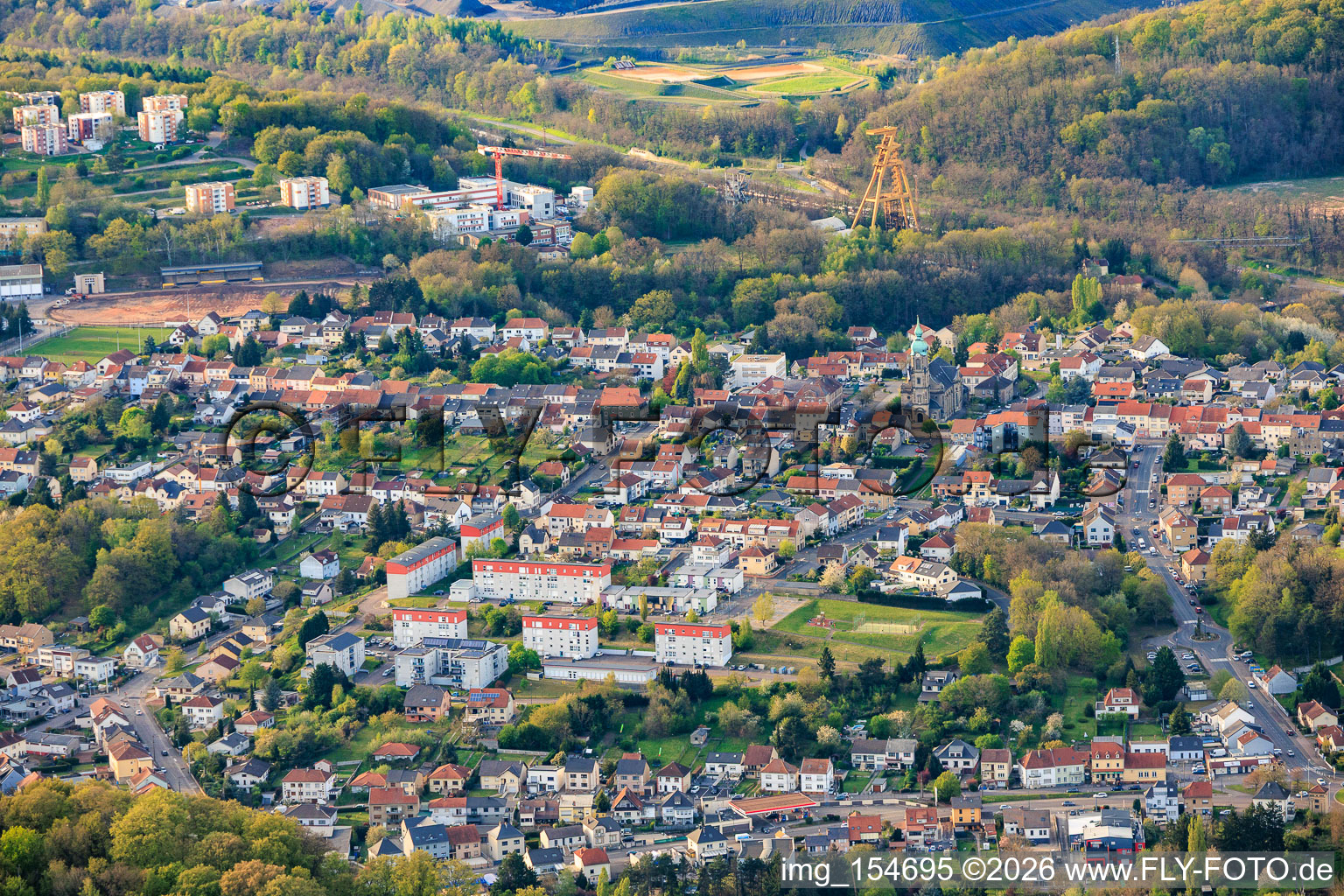 City view from the south in front of the historic mine headframe Le puits Cuvelette Nord in the district Cité de la Chapelle in Freyming-Merlebach in the state Moselle, France