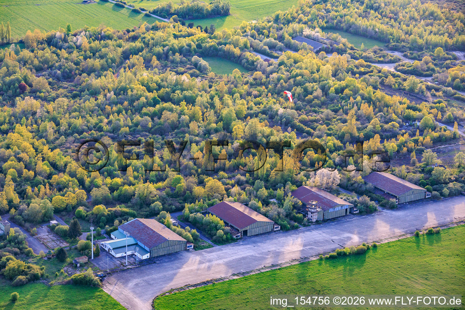 Paragliders over the hangars at the former military airfield Grostenquin in Bistroff in the state Moselle, France