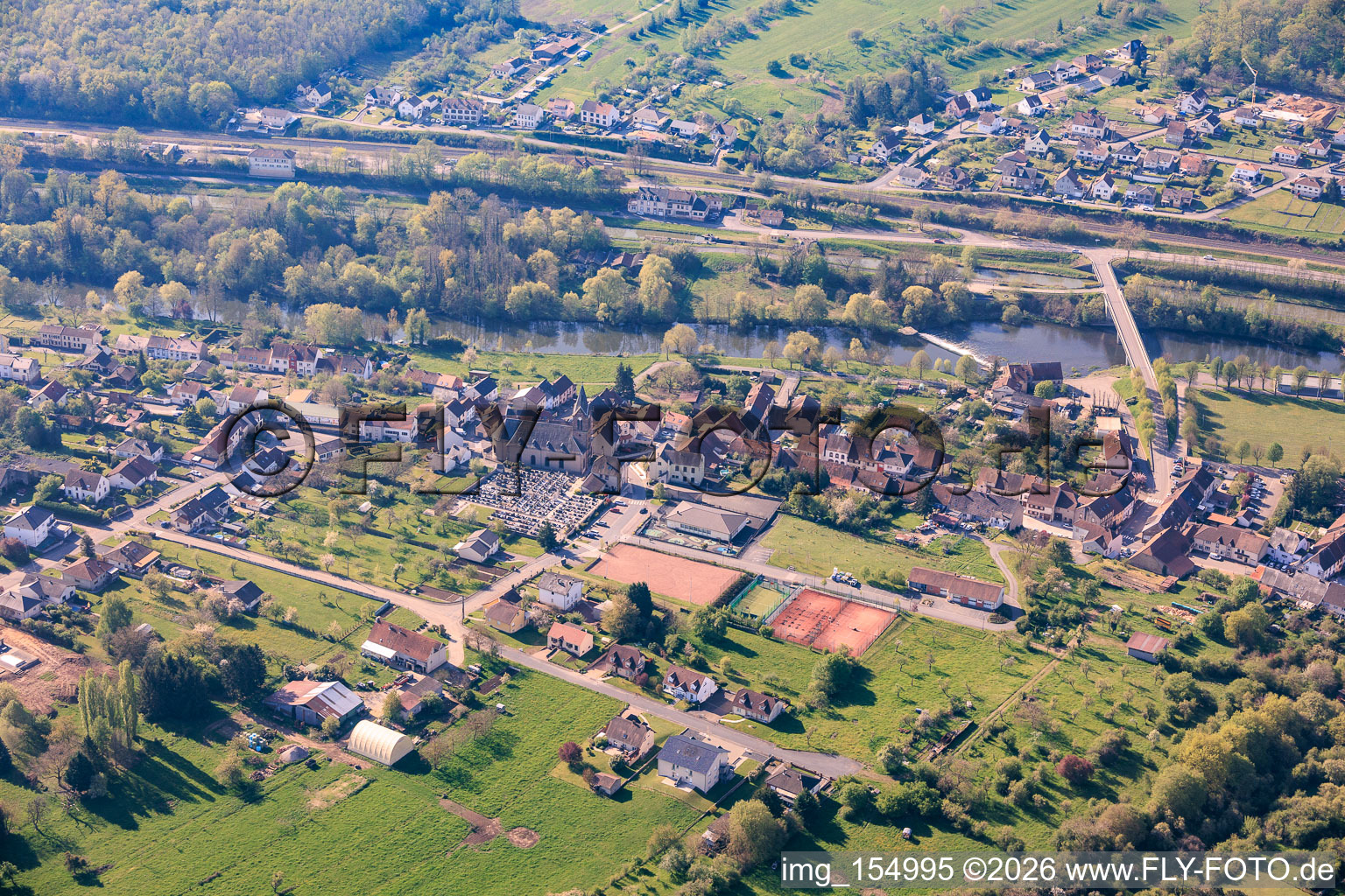 Old mill Saareinsmingen, church and cemetery on the banks of the Saar in Sarreinsming in the state Moselle, France